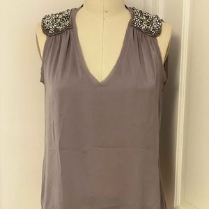 Grey sleeveless blouse with rhinestones on shoulders